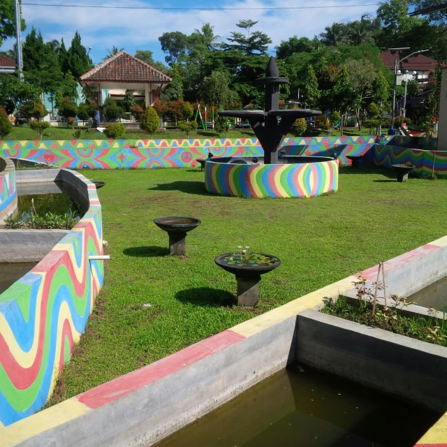 a park with a grass area with a lot of benches and benches on the lawn