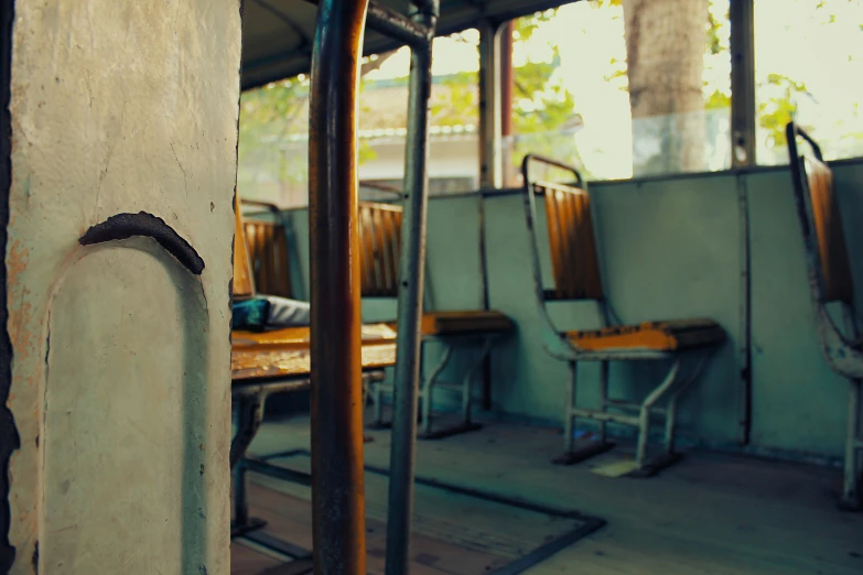 a row of metal and wood chairs under a tent