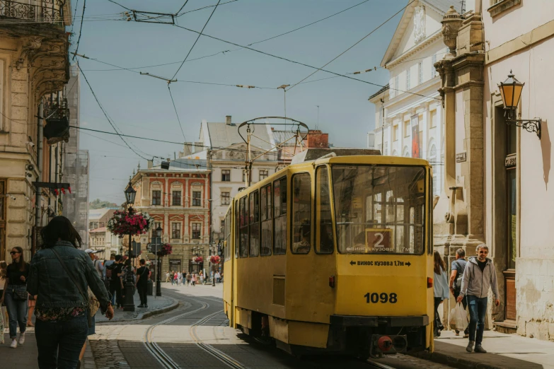 people walking and waiting for the tram to arrive