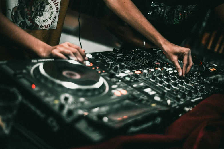 dj using the decks to mix up some music