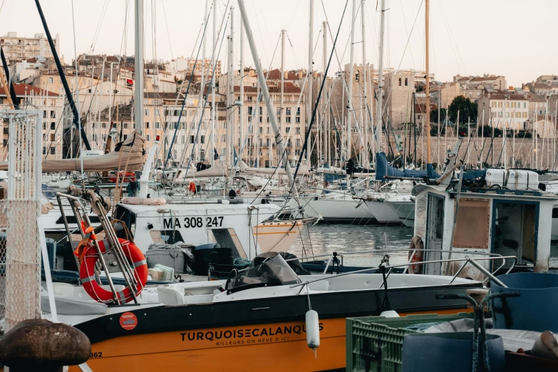 a row of boats sitting in the harbor next to each other