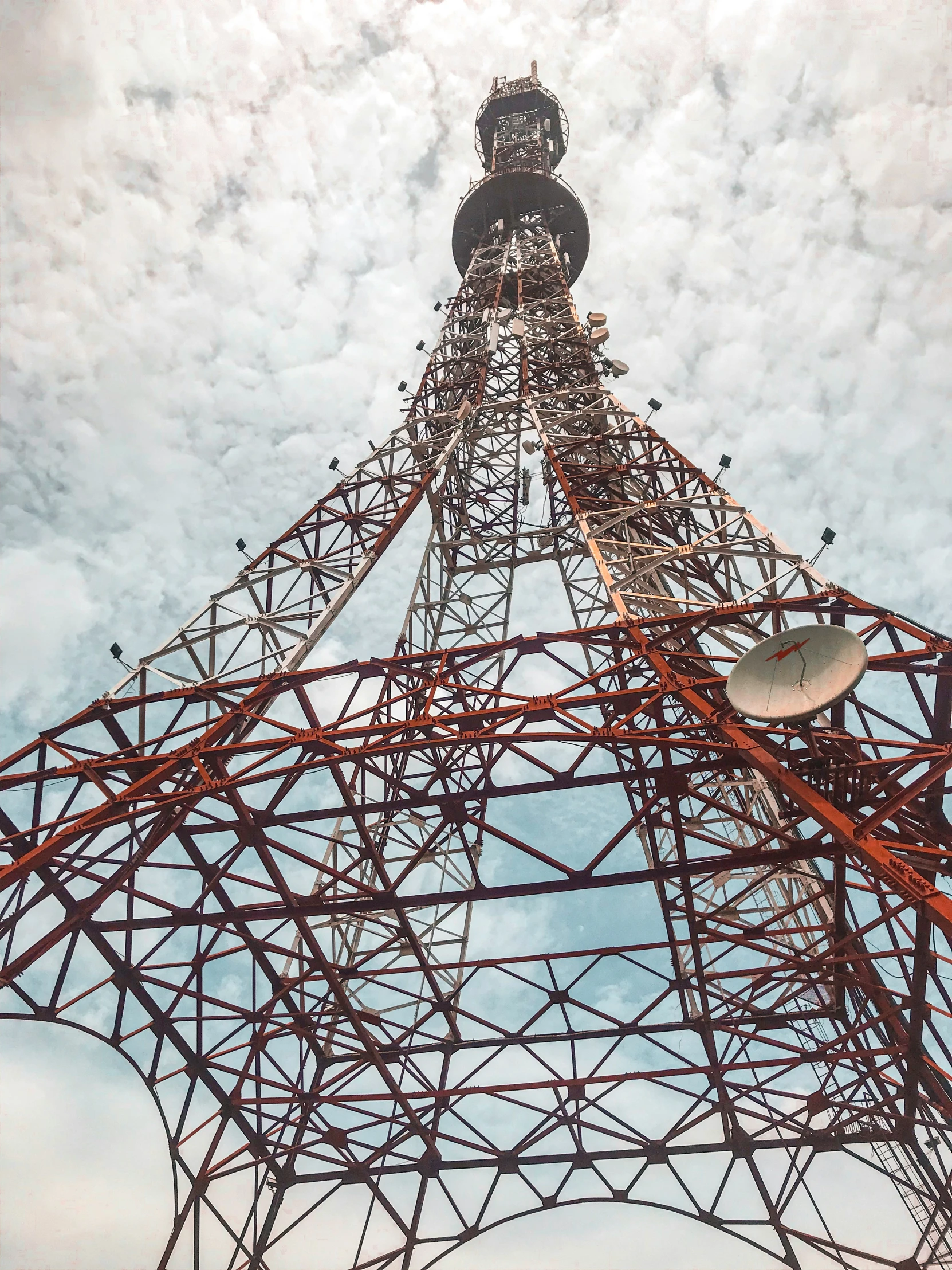 a metal structure is shown under some clouds