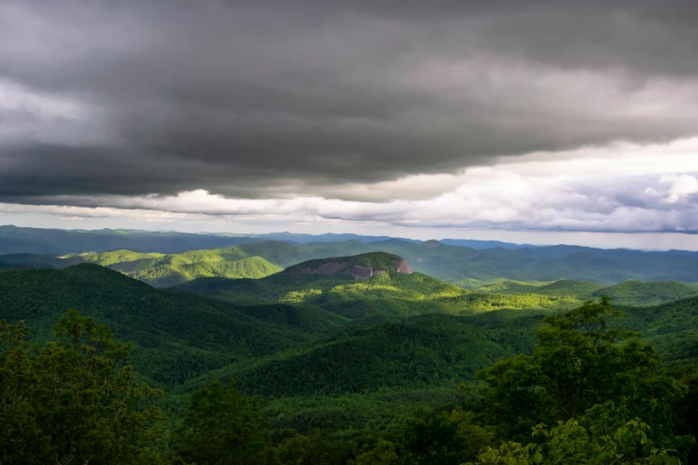 view of the mountains with some clouds on them