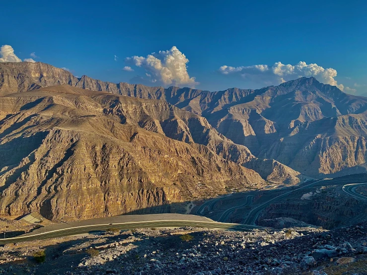 an airplane is flying above the mountains during the day