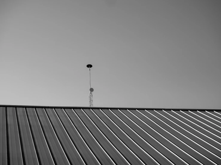 the top of the roof has a weather vane on it