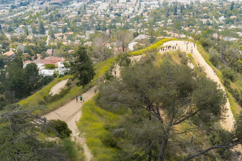 the view from the mountain above of a city and people