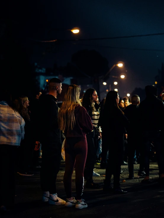a group of people standing next to each other in the dark