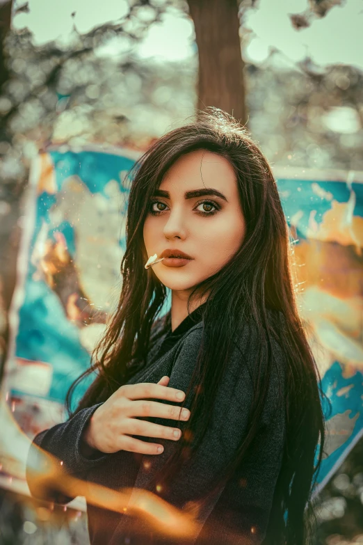 the woman is posing in front of an umbrella