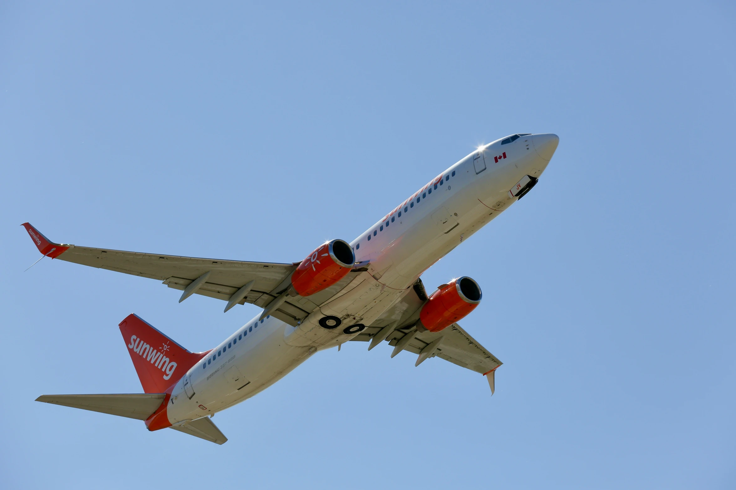 an air plane flying in the blue sky