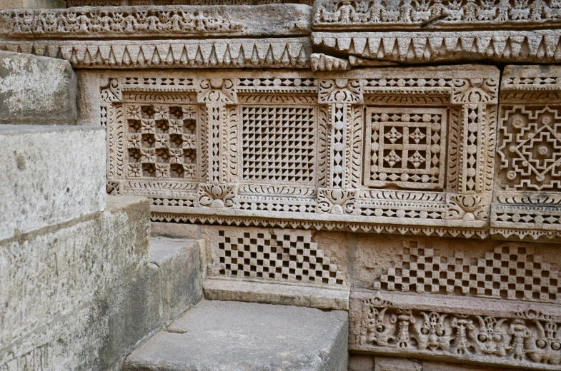 an elaborate wall carving and cement step