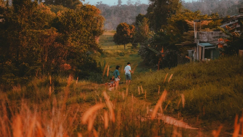 two people walking in the middle of a field