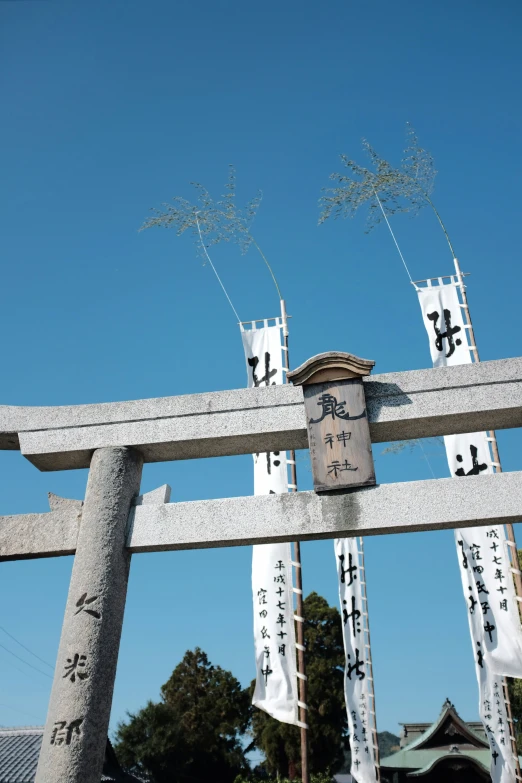 two giant statues made with a lot of japanese writing