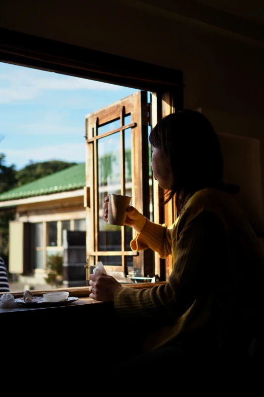 two women are sitting and having their coffee