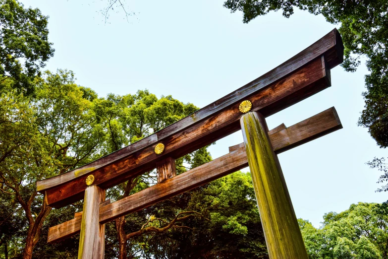 a wooden torido structure in front of trees