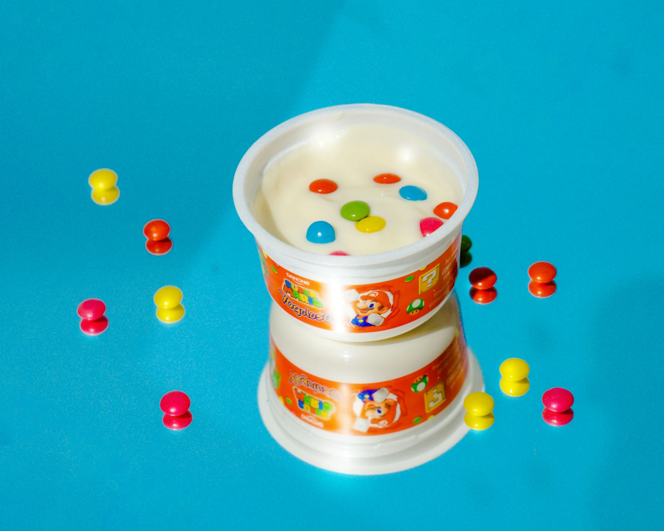 a small cup filled with some milk surrounded by confetti