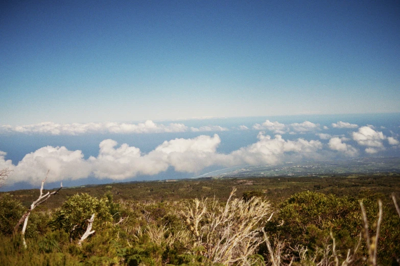 a sky view from the top of a grassy hill