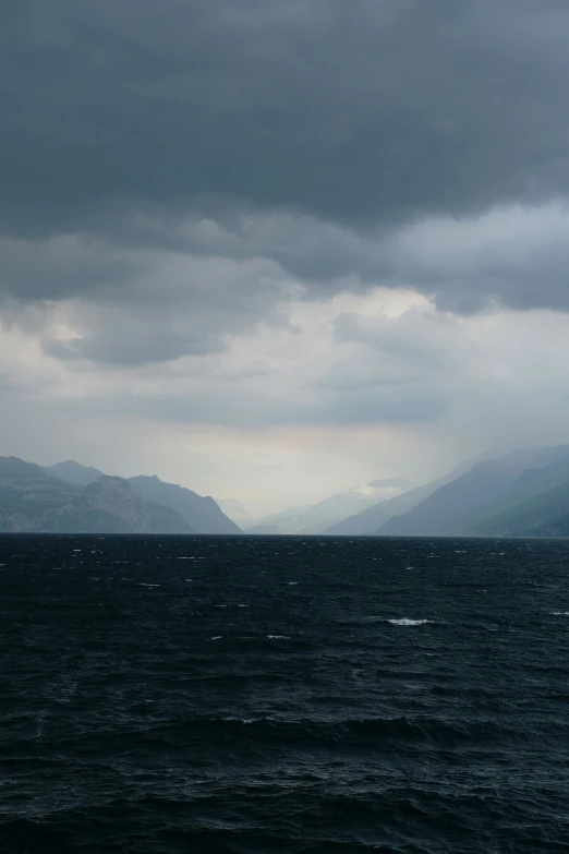 a sail boat is out in the middle of the ocean