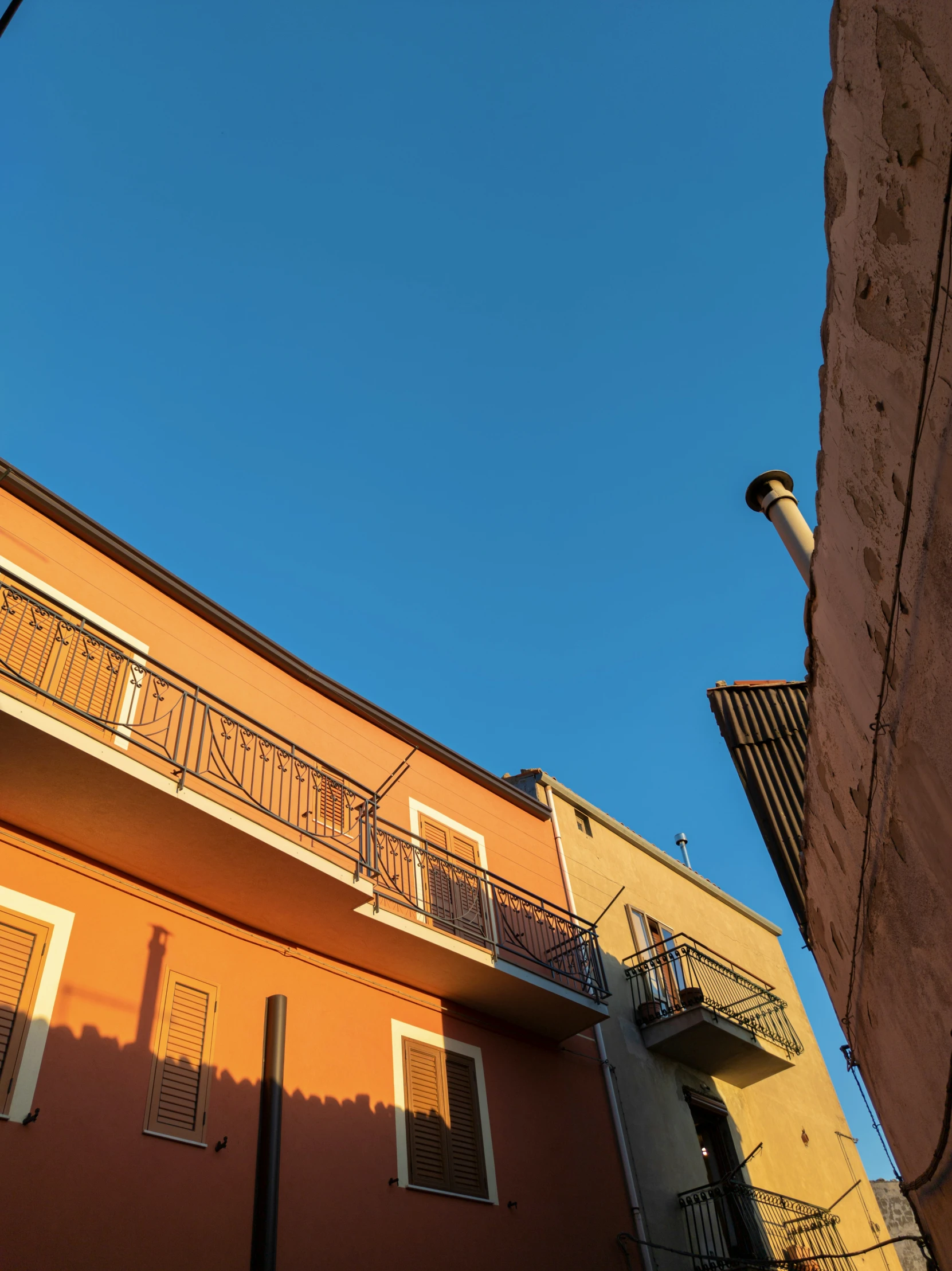 the tall building has two balconies above it