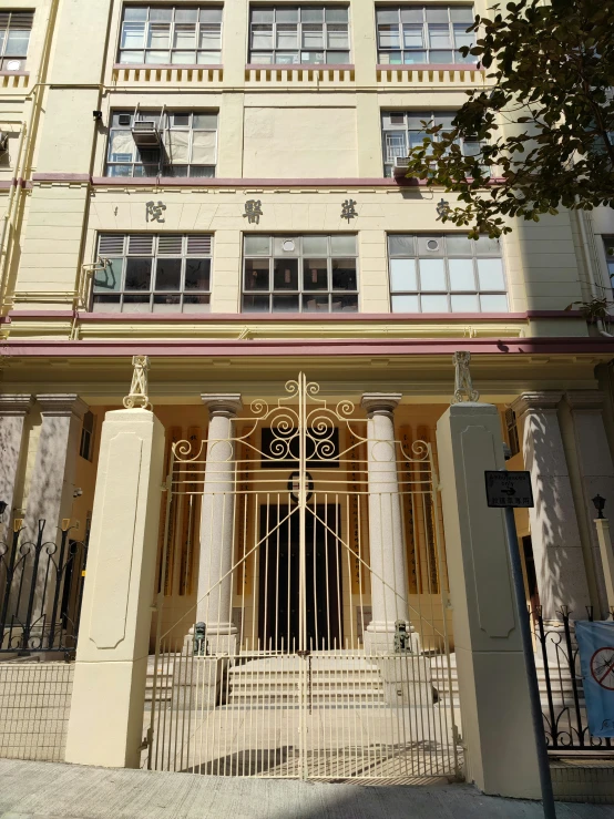 two very tall buildings with gold doors and white columns