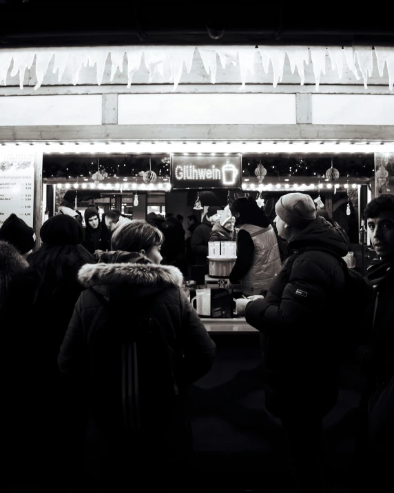 black and white po of people outside of a restaurant