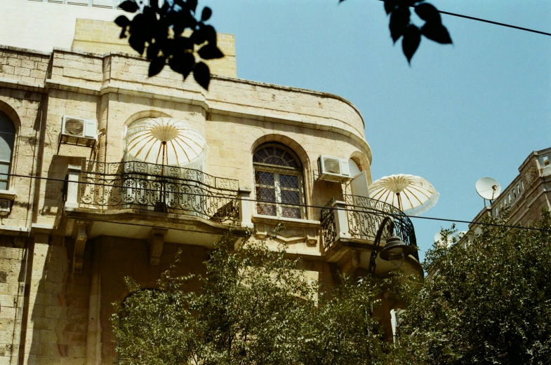 a building with some trees on the sides and many windows on top