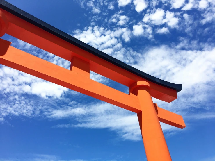 a large orange wooden structure in front of the sky