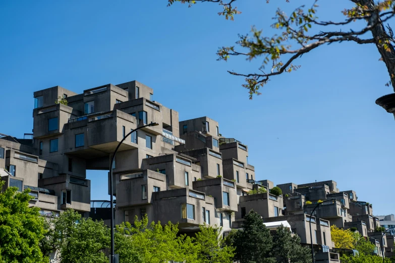 a tall building with many windows and lots of trees