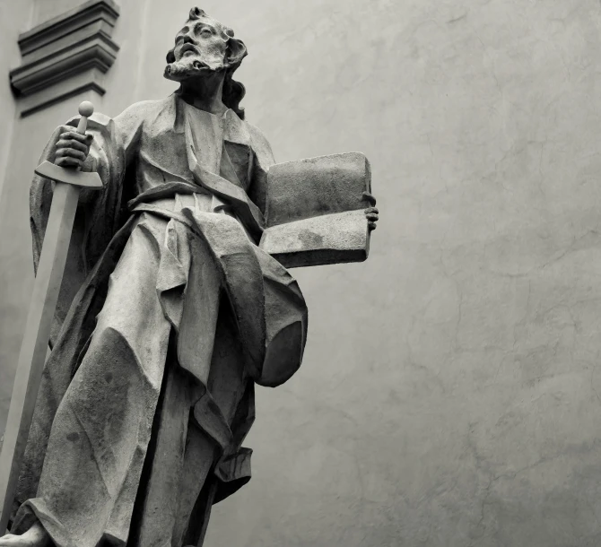 black and white po of statue of christ holding a cross