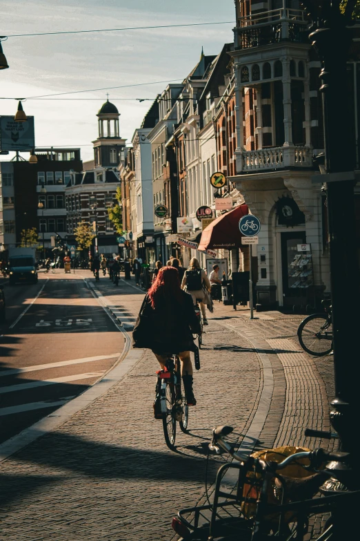 some people ride their bikes down the city street