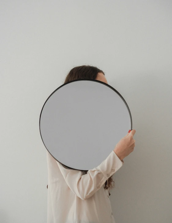 a woman holding a large disc in her hand