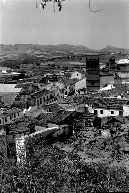 the roof tops of old houses stand barren in a town