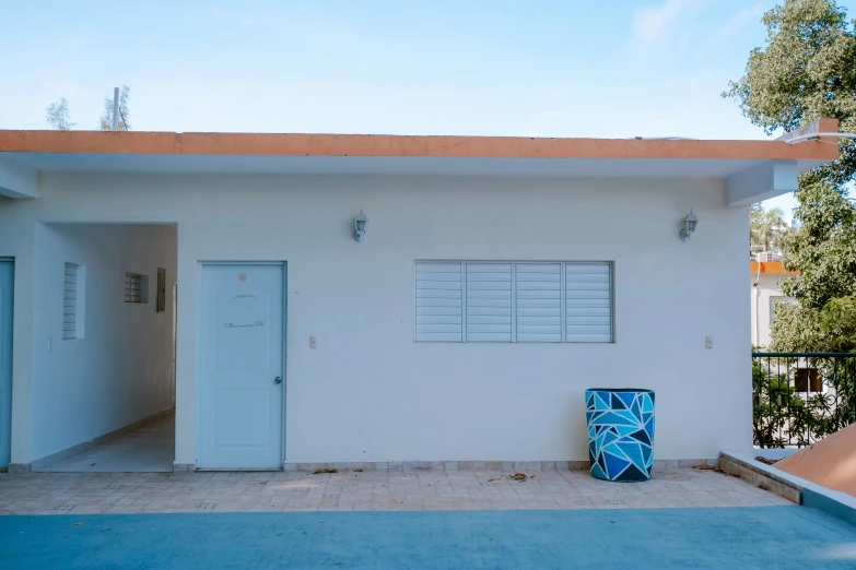 a small white building with several blue and white things