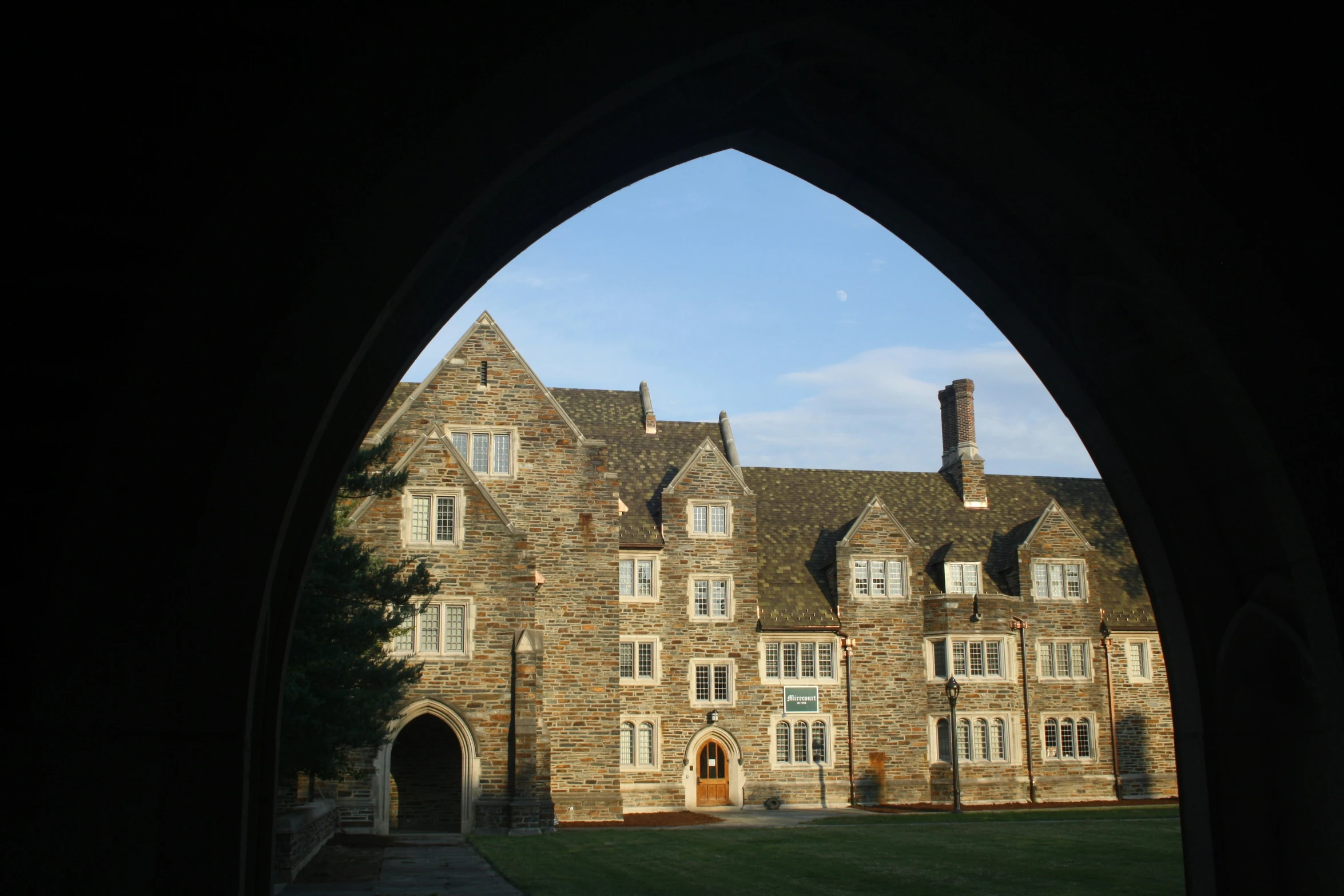 an arched doorway view of an old castle like building