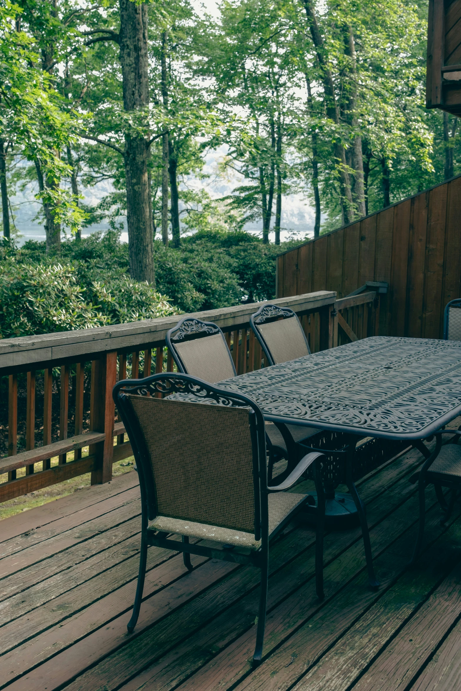 some chairs and a table on a wooden deck