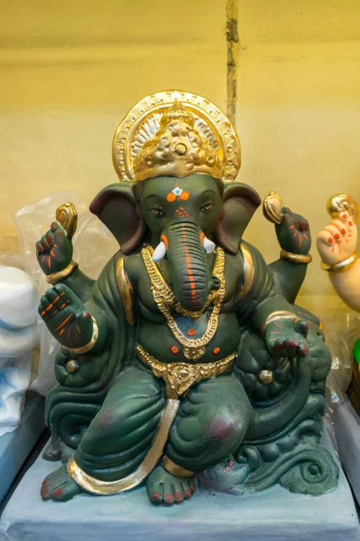 an elephant statue with some small figurines around it