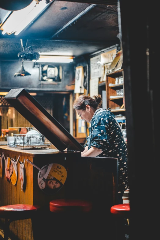 a woman is sitting at a piano in a dimly lit room