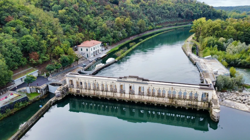 an aerial view of a river next to a building