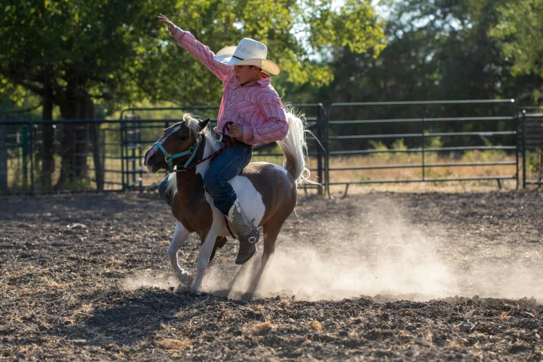 the girl is riding a horse around an arena