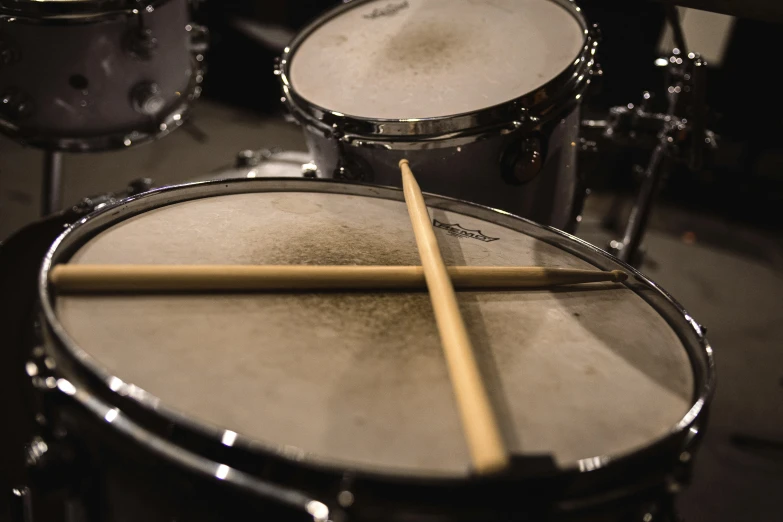 a drum kit on the ground with sticks