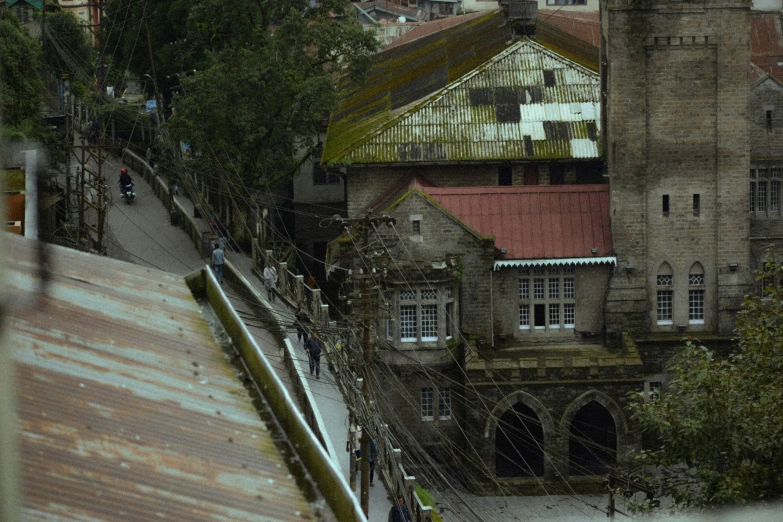 some people and an umbrellas over the top of an old building