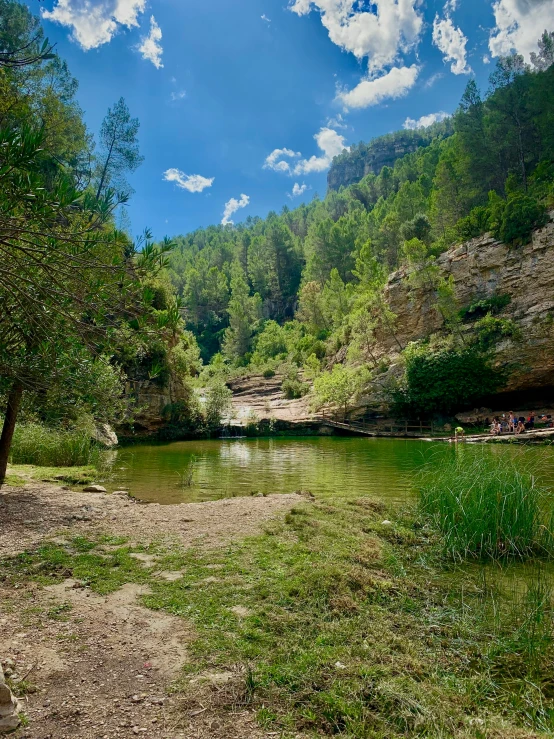 an outdoor pond is in the middle of a small valley