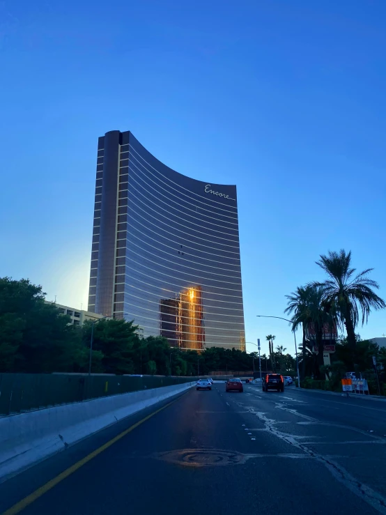 a very large tall building near a road