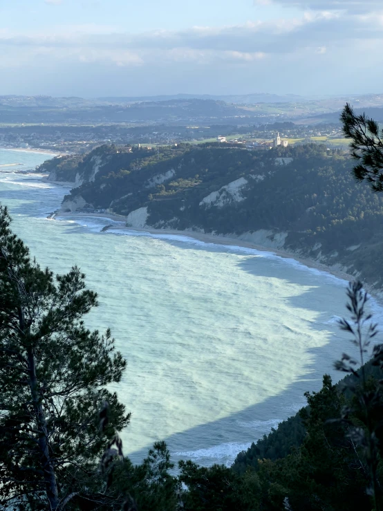 a view of the ocean in the distance and trees