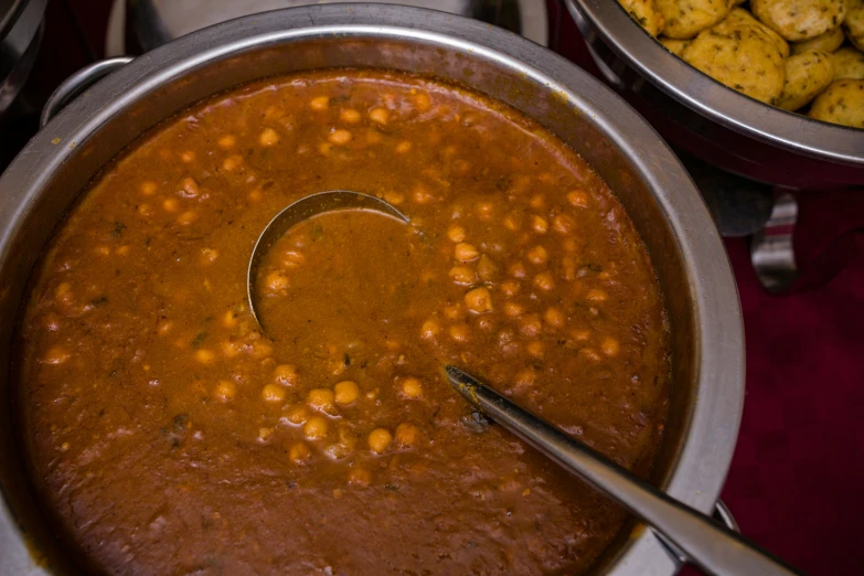 a pot filled with beans and corn