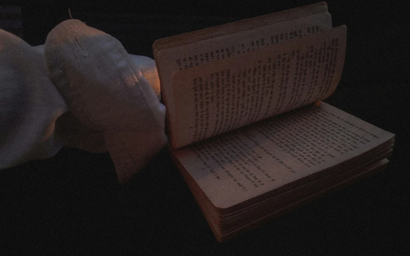 an illuminated book in the dark with paper