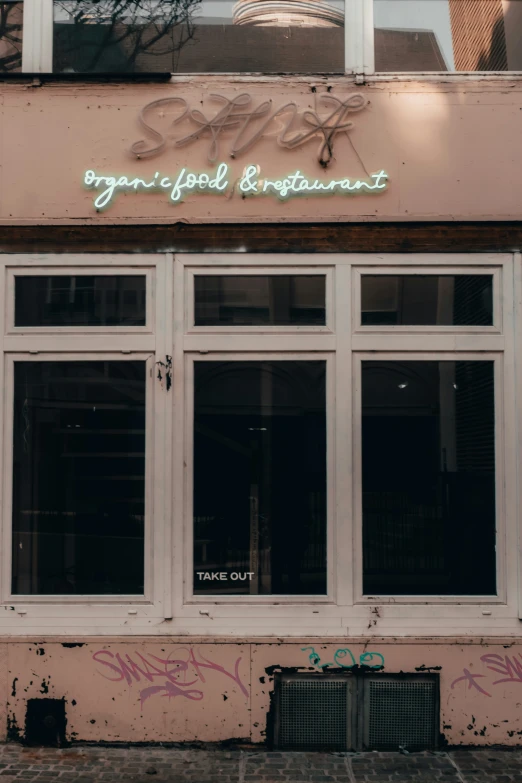 the front door to a restaurant with graffiti on it