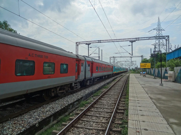 the train is stopped along side the railroad tracks