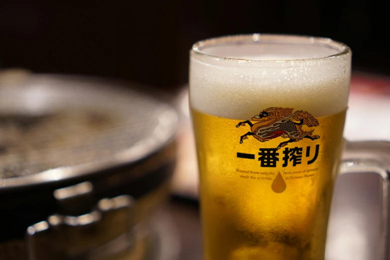 a close up of a glass cup with beer