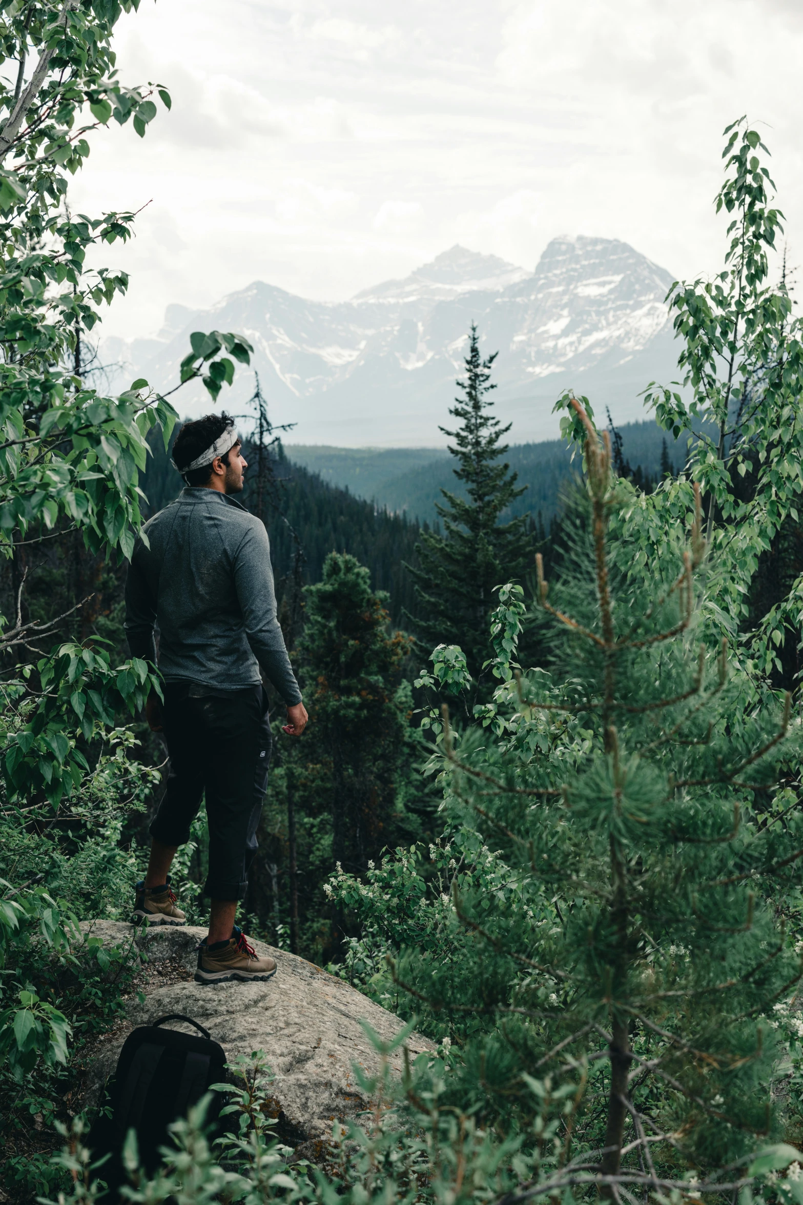 the man is standing on the rocks and admiring the view