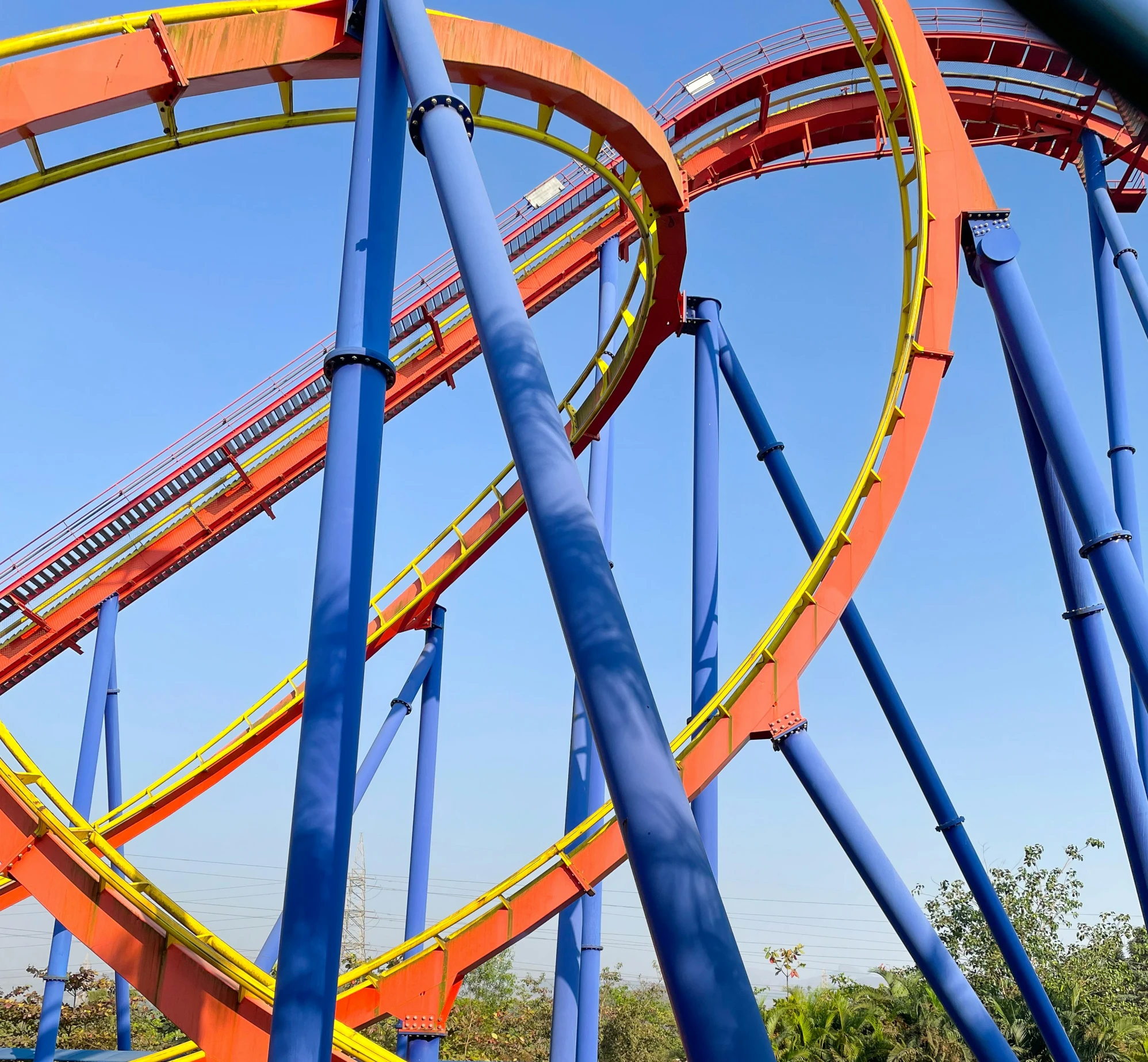 roller coaster coaster at a fair with blue skies in the background